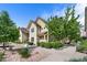 Inviting two-story home with verdant landscaping and a well-manicured lawn on a sunny day at 5444 Zephyr St # 203, Arvada, CO 80002