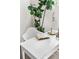Bright home office area with a white desk, stylish lamp, and a vibrant green houseplant at 5444 Zephyr St # 203, Arvada, CO 80002