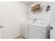 Laundry room with a side-by-side washer and dryer, wire shelving, and light tile floors at 5444 Zephyr St # 203, Arvada, CO 80002