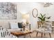 Cozy living room setup with a comfortable sofa, unique wood coffee table, and decorative accent chairs at 5444 Zephyr St # 203, Arvada, CO 80002