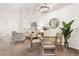 Open-concept living room with modern furnishings, a stylish round mirror, and ample natural light at 5444 Zephyr St # 203, Arvada, CO 80002