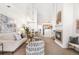 Bright living room featuring modern furnishings, a fireplace, and a spacious open floor plan to the kitchen and dining area at 5444 Zephyr St # 203, Arvada, CO 80002