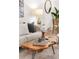 Living room featuring a comfortable sofa, modern art, a unique coffee table, and natural light at 5444 Zephyr St # 203, Arvada, CO 80002