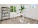 Bright office space featuring a white desk, large houseplant, and sunny windows at 5444 Zephyr St # 203, Arvada, CO 80002