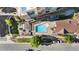 Top-down aerial view of the pool area with lounge chairs, umbrellas, and a spa tub at 5444 Zephyr St # 203, Arvada, CO 80002