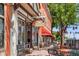 Charming brick building featuring 'The Bluegrass' coffee and bourbon lounge and outdoor seating at 5444 Zephyr St # 203, Arvada, CO 80002