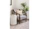 Cozy sitting area featuring a chair, a plant, a side table with geometric design, and a book at 5444 Zephyr St # 203, Arvada, CO 80002