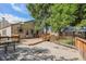 Spacious wooden backyard deck perfect for entertaining and relaxation, surrounded by mature trees and lush greenery at 7834 S Windermere Cir, Littleton, CO 80120