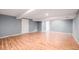Spacious basement featuring hardwood floors, neutral colors, and ample lighting at 7834 S Windermere Cir, Littleton, CO 80120