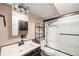 Well-lit basement bathroom includes a vanity, mirror, and tiled shower-tub combo at 7834 S Windermere Cir, Littleton, CO 80120