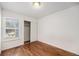 Clean bedroom featuring hardwood floors, a closet, and a sunny window at 7834 S Windermere Cir, Littleton, CO 80120