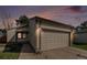 Charming home exterior showcases a two-car garage, well-maintained lawn, and cozy curb appeal at 7834 S Windermere Cir, Littleton, CO 80120