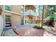 Backyard brick patio with landscaping and a view of the unit's brick exterior and balcony at 2500 S York St # 116, Denver, CO 80210