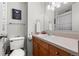 Bathroom featuring a vanity with a sink, mirror, and toilet with neutral colors at 2500 S York St # 116, Denver, CO 80210