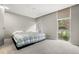 Bright bedroom featuring a cozy bed with a quilt and large windows that let in natural light at 2500 S York St # 116, Denver, CO 80210