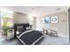 This primary bedroom is bright, features modern decor and includes a comfortable sitting area at 2500 S York St # 116, Denver, CO 80210