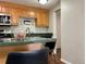 Kitchen with wooden cabinets and hardware, stainless steel appliances, and a peninsula with seating at 2500 S York St # 116, Denver, CO 80210