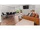 Open-concept living room featuring hardwood floors, modern furniture, and large windows offering abundant natural light at 2500 S York St # 116, Denver, CO 80210