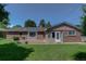 Large backyard of a brick house with a brick patio and a healthy lawn for activities at 2920 S York St, Denver, CO 80210