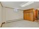Basement featuring linoleum floor, white walls, and a wooden built-in closet at 2920 S York St, Denver, CO 80210