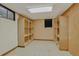 Basement featuring linoleum floor, wooden shelves, and window at 2920 S York St, Denver, CO 80210