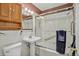 Bathroom featuring a vanity sink, glass enclosed shower, and overhead cabinet at 2920 S York St, Denver, CO 80210