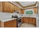 Well-lit kitchen with stainless steel appliances, light countertops and wooden cabinets at 2920 S York St, Denver, CO 80210