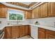 Updated kitchen with stainless steel appliances, wood cabinets, and bright lighting at 2920 S York St, Denver, CO 80210
