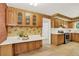 Charming kitchen with oak cabinets, white countertops, and decorative wallpaper at 2920 S York St, Denver, CO 80210