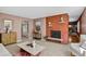 Living room showcasing a brick fireplace, neutral walls, and comfortable seating arrangement at 2920 S York St, Denver, CO 80210