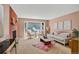 Bright living room with a brick fireplace, comfortable seating, and abundant natural light at 2920 S York St, Denver, CO 80210