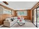 Comfortable living room with paneled walls, plush white sofa and lots of natural light at 2920 S York St, Denver, CO 80210