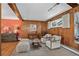 Cozy living room with wood paneling, comfortable seating, and ample natural light at 2920 S York St, Denver, CO 80210