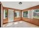 Sunroom featuring tile floor, wood paneling, and many windows at 2920 S York St, Denver, CO 80210