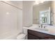 Bathroom features a single sink vanity with dark cabinets and a shower-tub combination at 888 S Valentia St # 101, Denver, CO 80247