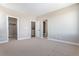 Carpeted bedroom with walk-in closet, linen closet, and ensuite bathroom at 888 S Valentia St # 101, Denver, CO 80247