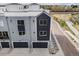An aerial view of townhomes with two-car garages and street parking in a well maintained community with landscaped streets at 888 S Valentia St # 101, Denver, CO 80247
