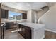 Well-lit kitchen features an island with white countertop and dark cabinetry at 888 S Valentia St # 101, Denver, CO 80247