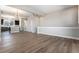 An open living room space with wood flooring, neutral walls, and staircase access at 888 S Valentia St # 101, Denver, CO 80247