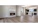 A spacious living room with a fireplace flows into a modern kitchen with dark cabinets and island seating at 888 S Valentia St # 101, Denver, CO 80247
