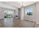 Open concept living room with modern lighting, a fireplace, and a large windows at 888 S Valentia St # 101, Denver, CO 80247