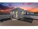 A rooftop deck with composite planks and a small building offers a private outdoor space with sunset views at 888 S Valentia St # 101, Denver, CO 80247