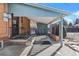 Covered patio with brickwork, access to backyard at 4830 W Vassar Ave, Denver, CO 80219