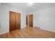 Bedroom with hardwood floors and double door closet at 4830 W Vassar Ave, Denver, CO 80219