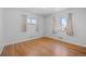 Bright bedroom with hardwood floors and large windows at 4830 W Vassar Ave, Denver, CO 80219