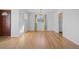 Hardwood floor dining room with chandelier and view to kitchen at 4830 W Vassar Ave, Denver, CO 80219