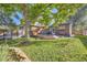 Landscaped backyard with a wooden deck, mature tree, and a cozy seating area perfect for outdoor entertaining at 1335 S Sherman St, Denver, CO 80210