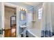 Bathroom with a pedestal sink and a classic bathtub featuring blue painted walls at 1335 S Sherman St, Denver, CO 80210