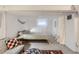 Basement bedroom with a comfortable bed, sitting area, and ample natural light at 1335 S Sherman St, Denver, CO 80210