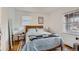 Cozy bedroom featuring a comfortable bed, natural light from the windows and hardwood floors at 1335 S Sherman St, Denver, CO 80210